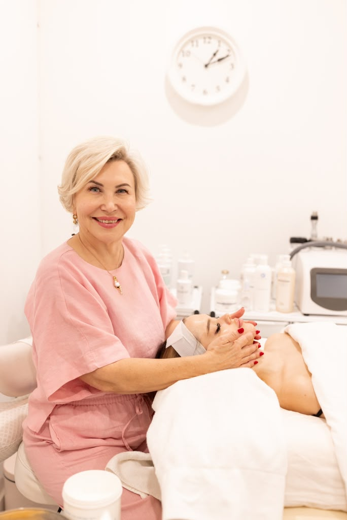Olena Pavelko providing a facial treatment to a client